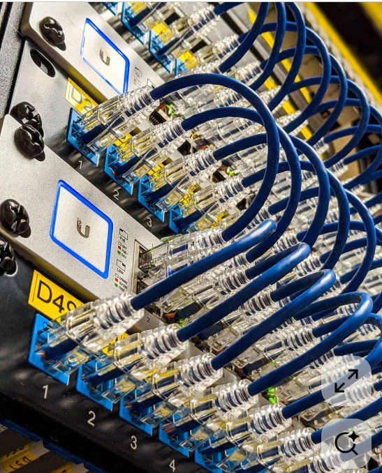 Technician installing network cable lines on industrial site