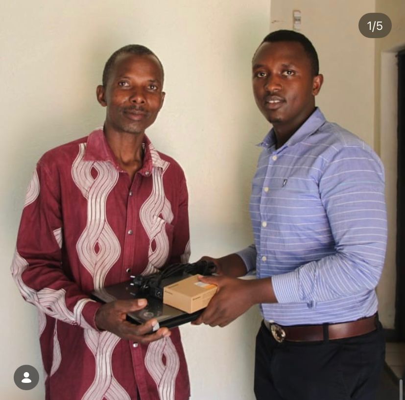 1000Hills team member handing over technology equipment to client